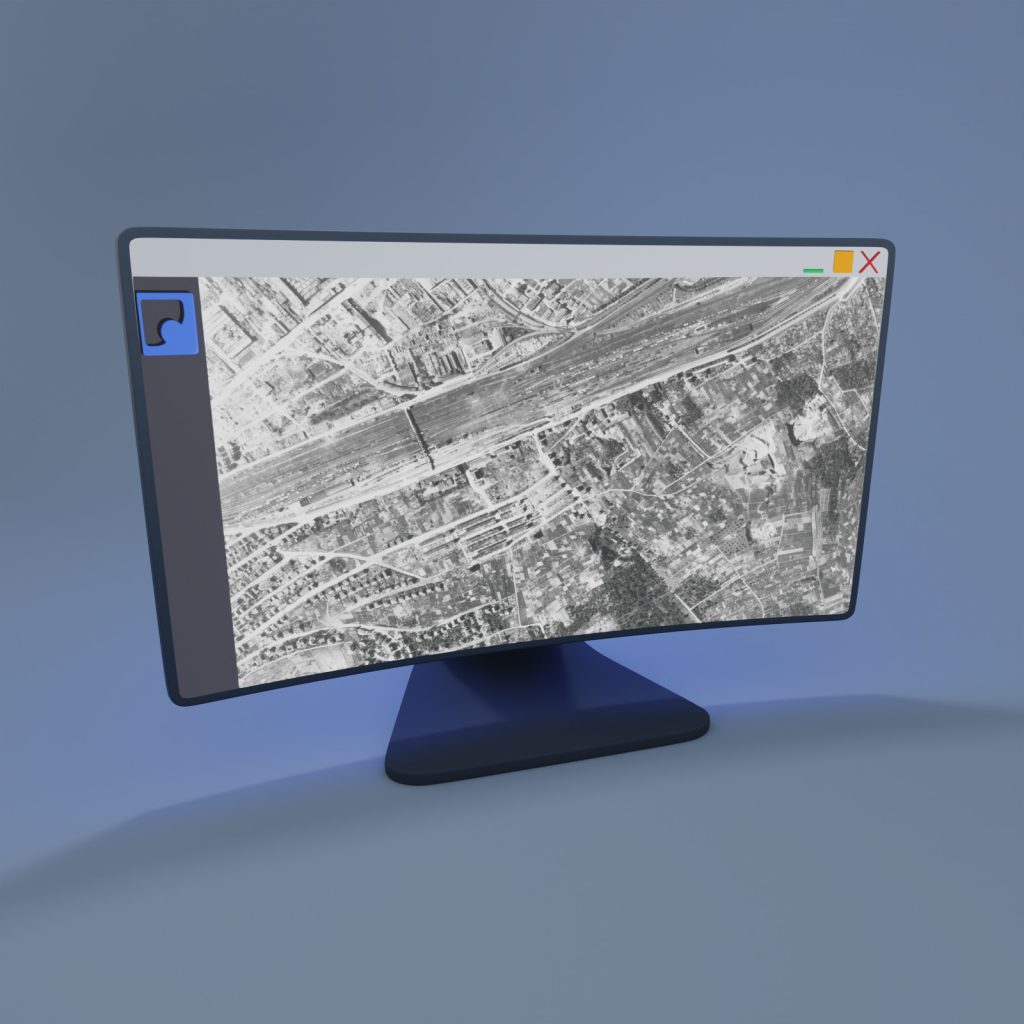 Monitor mit einem historischen Luftbild aus dem Archiv auf einem blauen Hinter- und Untergrund.